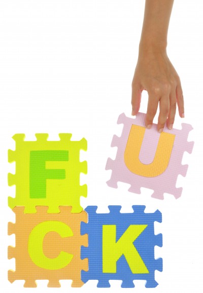 Hand forming word "Fuck" with jigsaw puzzle pieces isolated